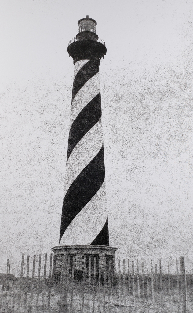 The Cape Hatteras Light Station, first lit in 1870, protects ships from the dangerous Diamond Shoals off the NC Outer Banks. B&W handcrafted alternative process photograph (original silver emulsion print from paper negative). © WJ Eastman Offered by GALLERY5X7.