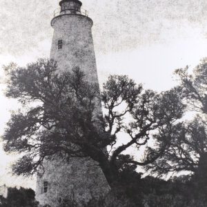The Ocracoke Island Lighthouse has been a landmark of the NC Outer Banks since 1823. View of the Light through neighboring oak trees. B&W handcrafted alternative process photograph (original silver emulsion print from paper negative). "Ocracoke Island Light Oak" © WJ Eastman. Offered by GALLERY5X7.