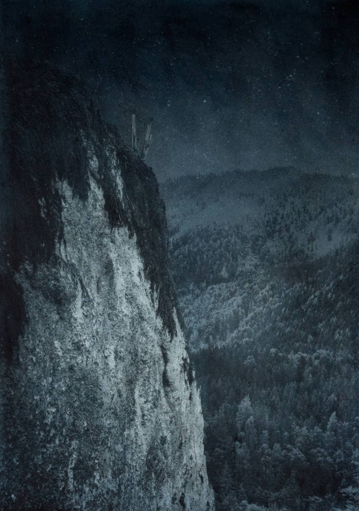 Mystery surrounds a lonely outcropping in ski country. Approx. 28” x 20" handcrafted alternative process print (antracotypia (resinotype) on white plastic board; natural indigo pigment; wood frame, no glass). Edition #1/10. Signed original print offered by GALLERY5X7 at $1,000.