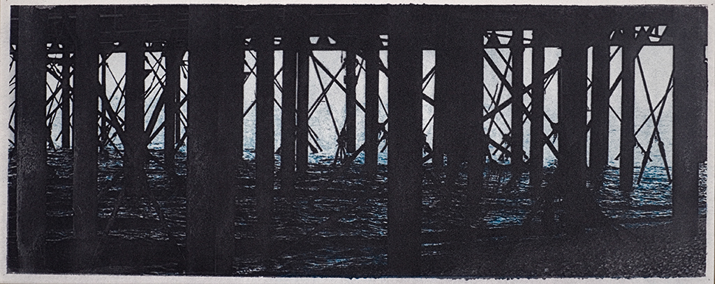 "Worthing Pier" © Alan Glover. Approx 13.5x5” handcrafted gum bichromate print from 2 negatives using watercolour pigments on Hahnemuhle Platinum Rag paper. GALLERY5X7 offers this original print, signed on the mount (mount size 17.5x9”), at $250.