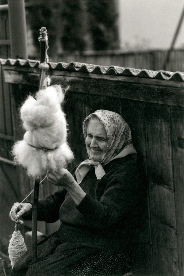 "Spinning Sheep Wool By Hand Wheel, Romania" © Mohan Bhasker. While driving through the remote countryside of Romania, I encountered this moment, an elderly woman with a big smile spinning her wheel as she truly enjoyed her craft and was happy that I was photographing her. Approx. 6x9" (15x23cm) or 12x18" (31x46cm) handcrafted alternative process photograph (platinum/palladium) on Revere Platinum. Signed, original editioned (1/10) print offered by GALLERY5X7.