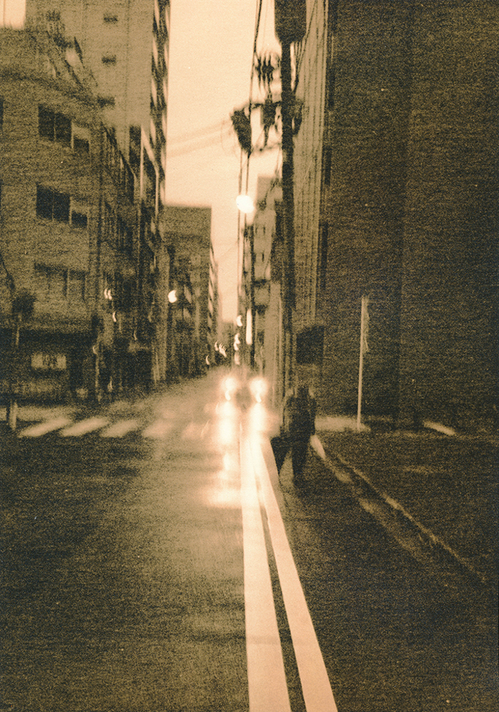 "Tokyo Lonely Walker" © Marek Majewski. Approx. 9.5x12" (24x30.5cm) handcrafted alternative process photograph (silver gelatin lith print) on Foma paper. Signed, original, editioned print (limited to 10) offered by GALLERY5X7.